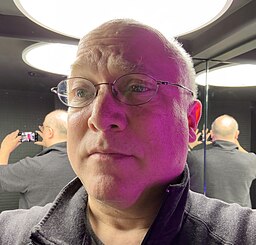 This is a photo of the author, designer, and historian Glenn Fleishman in a Berlin bathroom photographed with mirrored from all angles.