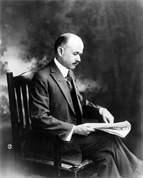 Ben Lindsey, American judge and social reformer, reading newspaper