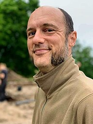 An outdoor portrait of Swedish archaeologist Martin Rundkvist on excavation at Aska in Hagebyhöga in August 2020